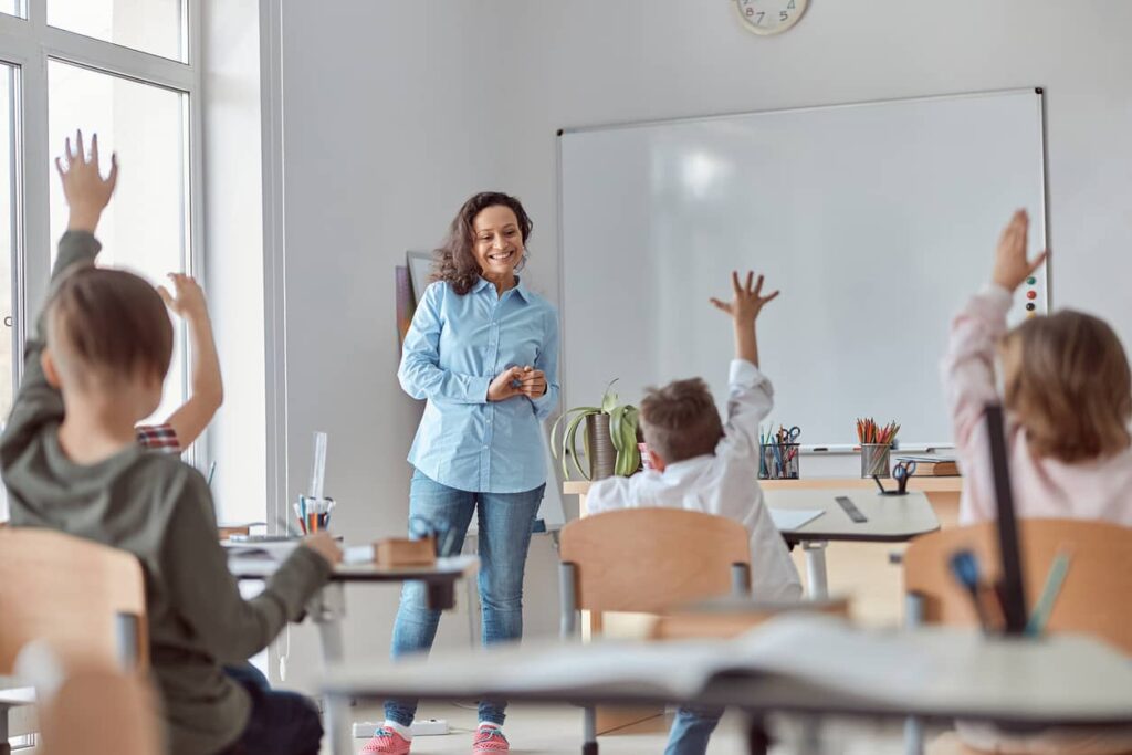 juf vraagt kinderen in de klas naar antwoorden op raadsels